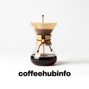 Chemex glass coffee maker with coffee brewing, minimal background